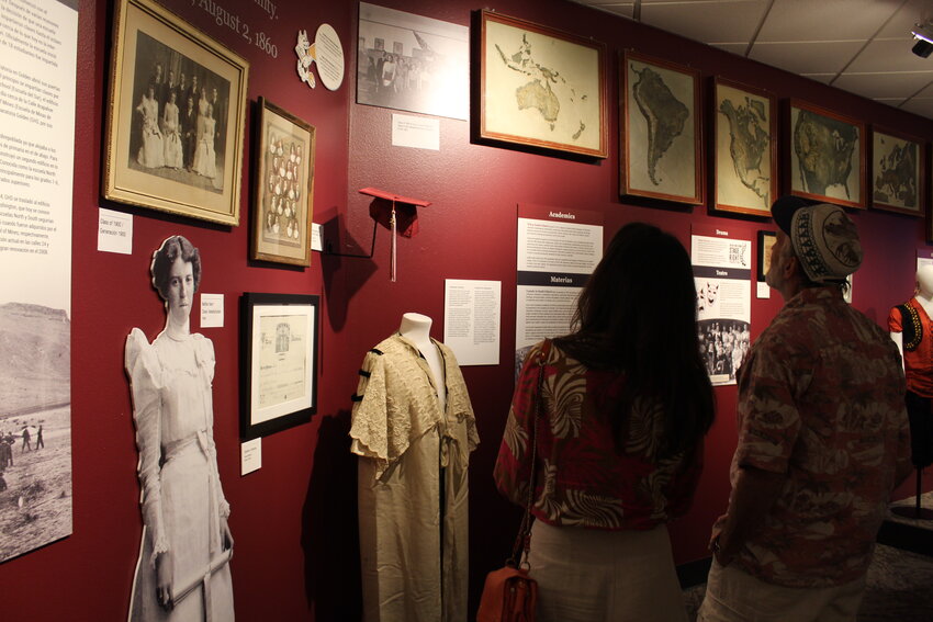 Golden High School alumni examine items from the school's early years during the Golden History Museum's Aug. 24 exhibit opening. The new exhibit, which gives a general overview of GHS' 150-year history, will run for at least a year.